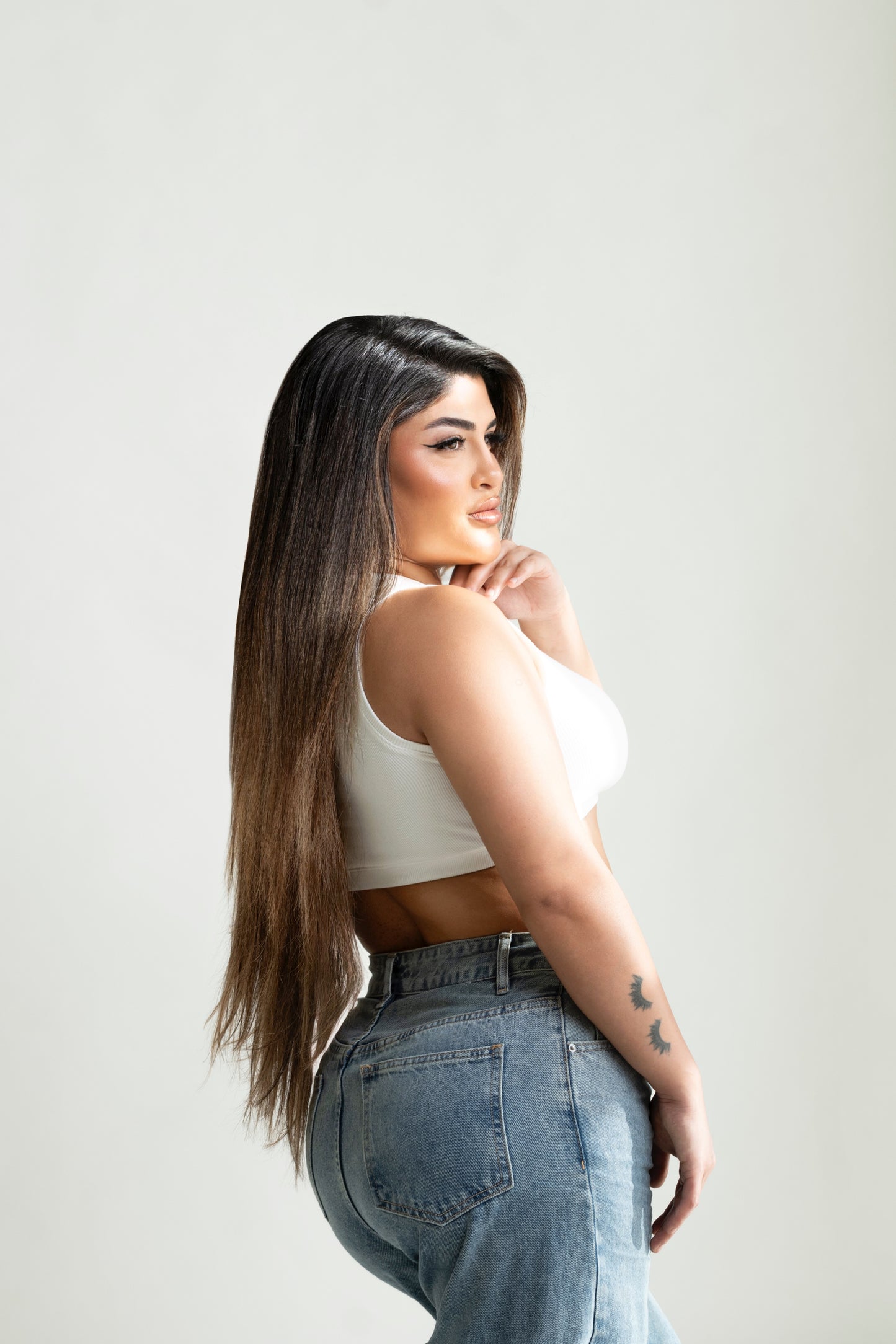 Woman wearing 22 inch light balayage hair extensions back view